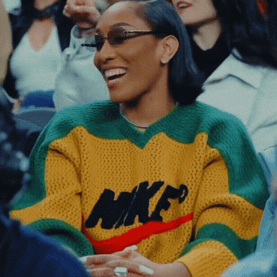 Woman In Yellow Green Red Nike Sweater Smiling GIF