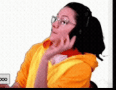 Woman In Yellow Hoodie Talking On Phone GIF