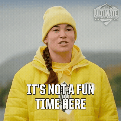 Woman In Yellow Jacket And Beanie Says It's Not A Fun Time Here GIF