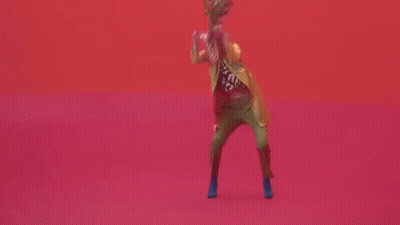 Woman In Yellow Jacket And Green Pants Dancing GIF