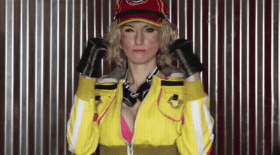 Woman In Yellow Jacket And Red Hat With Bandana And Gloves GIF