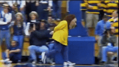 Woman In Yellow Jacket Dancing In Crowd GIF
