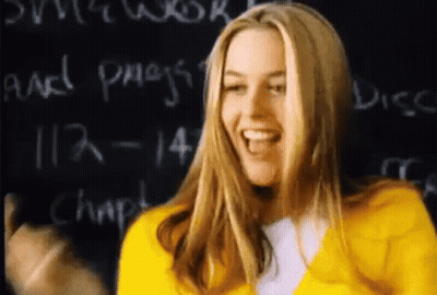 Woman In Yellow Jacket Laughing At Blackboard GIF