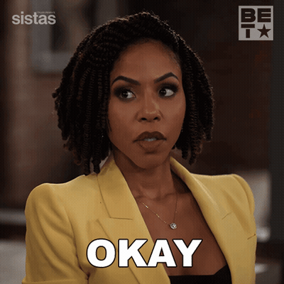 Woman In Yellow Jacket Saying Okay GIF