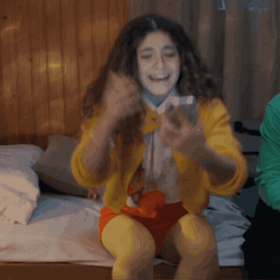 Woman In Yellow Jacket Taking Selfie GIF