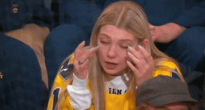 Woman In Yellow Jersey Crying In Crowd GIF