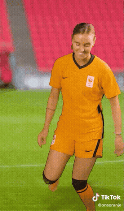 Woman in Yellow Nike Jersey Dancing on Soccer Field