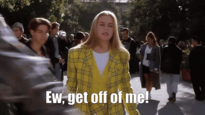 Woman In Yellow Plaid Jacket Saying Ugh In Crowd GIF