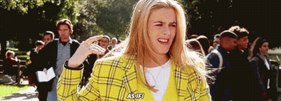 Woman In Yellow Plaid Jacket Talking To Crowd GIF