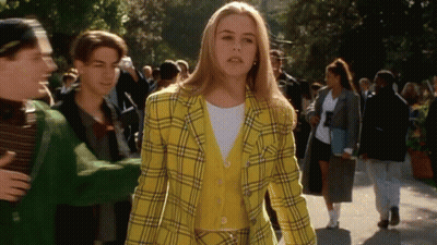 Woman In Yellow Plaid Jacket Walking GIF