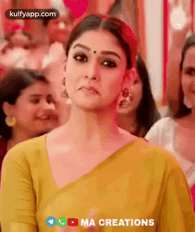 Woman In Yellow Saree Making Funny Face In Crowd GIF