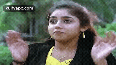Woman In Yellow Shirt And Black Jacket Making Funny Face GIF