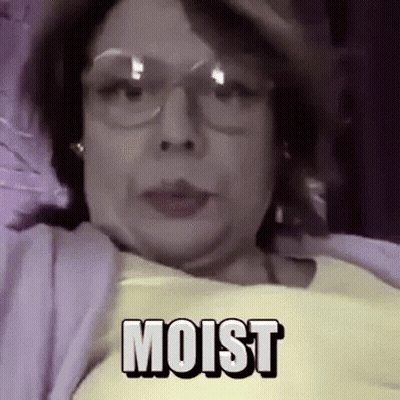 Woman In Yellow Shirt And Glasses Lying In Bed Moist GIF