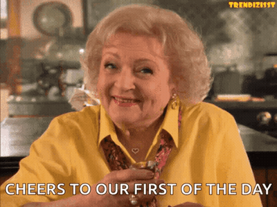 Woman In Yellow Shirt Cheers Whiskey First Of The Day GIF