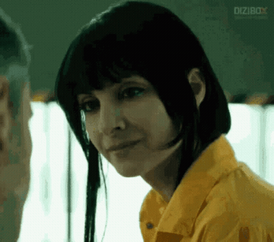 Woman In Yellow Shirt Looks At Man In Prison GIF
