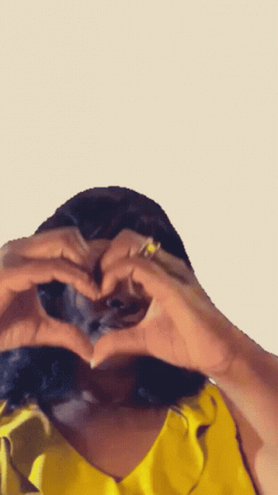 Woman In Yellow Shirt Making Heart GIF