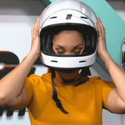 Woman In Yellow Shirt Putting On Helmet GIF