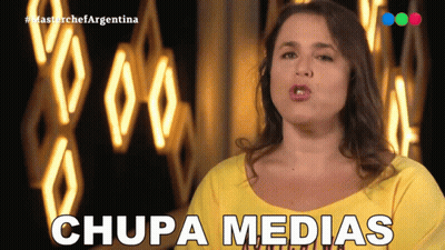 Woman In Yellow Shirt Says Chupa Medias In Front Of Neon Sign GIF