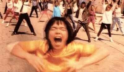 Woman In Yellow Shirt Screaming While People Dance GIF