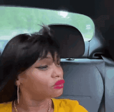Woman In Yellow Shirt Sitting In Backseat GIF