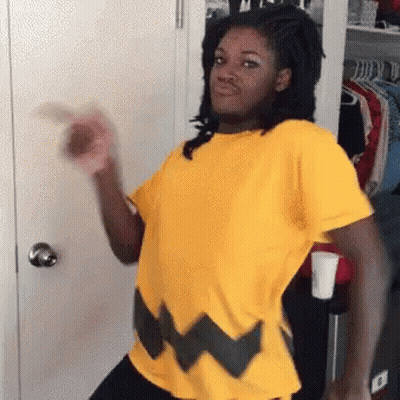 Woman In Yellow Shirt Standing By Closet GIF