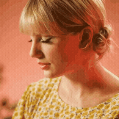 Woman In Yellow Shirt With Bun GIF