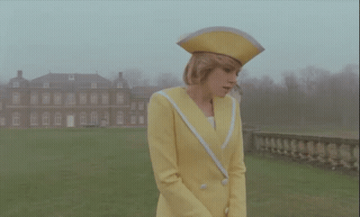 Woman In Yellow Suit And Hat GIF