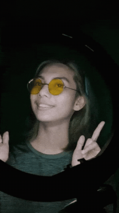 Woman In Yellow Sunglasses Giving Peace Sign GIF