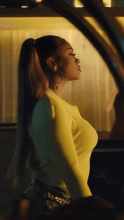 Woman In Yellow Sweater And Hoop Earrings At Car Window GIF