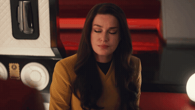 Woman In Yellow Sweater Looking Down GIF
