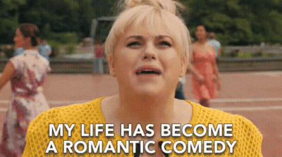 Woman In Yellow Sweater Saying My Life Has Become A Romantic Comedy GIF