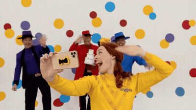 Woman In Yellow Sweater Saying Wiggles GIF