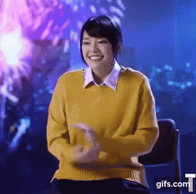 Woman In Yellow Sweater Smiling At Fireworks GIF