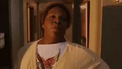 Woman In Yellow Sweater Standing GIF