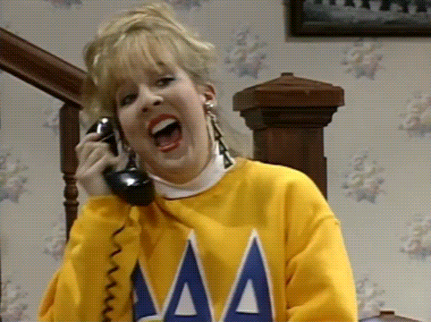 Woman In Yellow Sweater Talking On Phone GIF