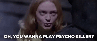 Woman In Yellow Sweater Talking To Man In Black Shirt GIF