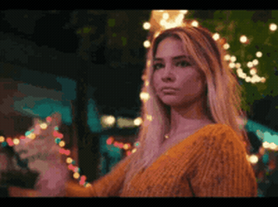 Woman In Yellow Sweater With Lights GIF