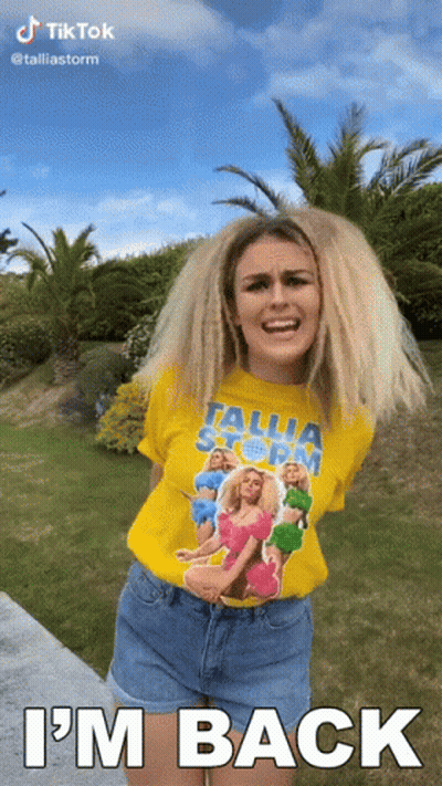 Woman In Yellow Tallia Storm T-Shirt Says I'm Back GIF