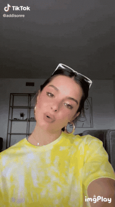 Woman In Yellow Tie Dye Shirt Taking Selfie With Sunglasses GIF