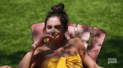 Woman In Yellow Top Sitting In Chair Saying Bravo GIF
