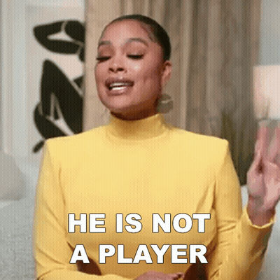 Woman In Yellow Turtleneck Saying He Is Not A Player GIF