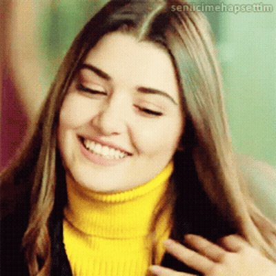 Woman In Yellow Turtleneck Smiling With Sen.icimehapsetim GIF