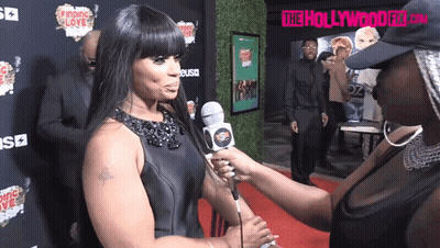 Woman Interviewed On Red Carpet In Front Of The Hollywood Fix Sign GIF