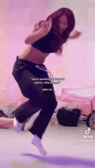 Woman Jumping In Black Crop Top And Sweatpants GIF