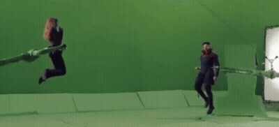 Woman Jumping In Front Of Green Screen With Clapper Board GIF