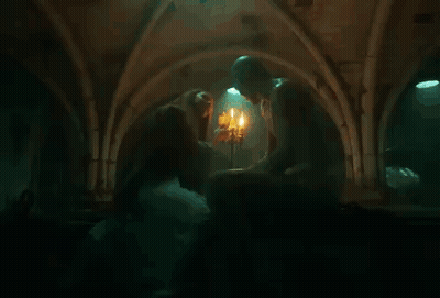 Woman Kissing Man In Front Of Candles GIF