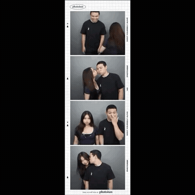 Woman Kissing Man On Cheek In Photo Booth Sponsored By Photoism GIF