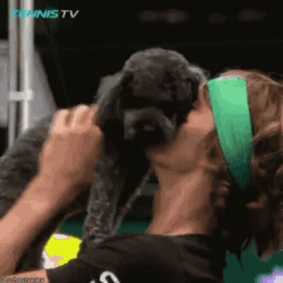 Woman Kissing Small Dog's Cheek At Tennis TV Logo GIF
