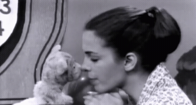 Woman Kissing Stuffed Animal In Black And White Photo GIF