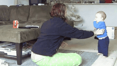 Woman Kneeling Holding Baby In Front Of Couch With Coffee Mug Letter O GIF